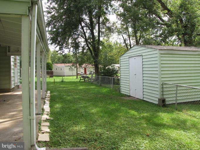 1832 Colmar Road Gwynn Oak, MD 21207 - Photo 10 of 12 a view of a backyard with large trees and plants