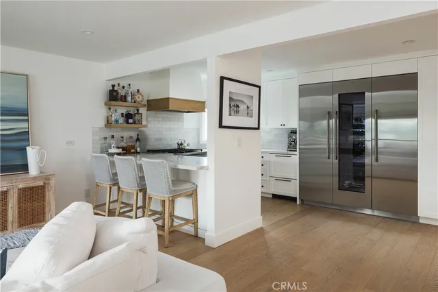 a living room with furniture and a kitchen area