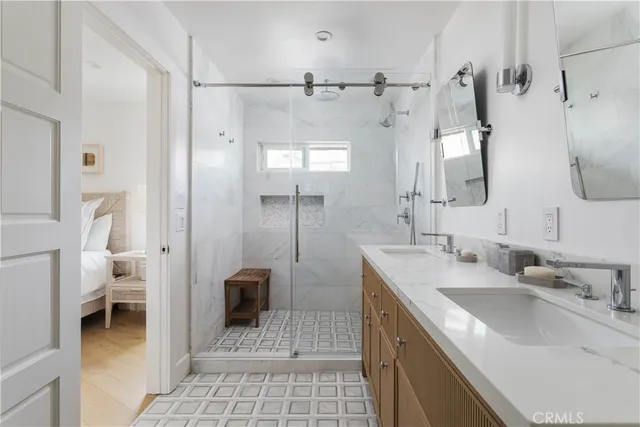 a bathroom with a sink a toilet and a large mirror