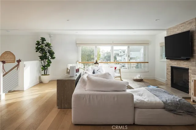 a living room with furniture a flat screen tv and a fireplace