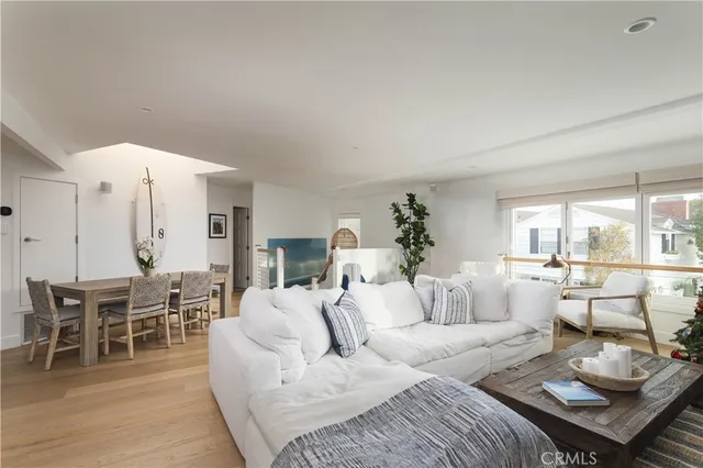a living room with furniture wooden floor and dining room