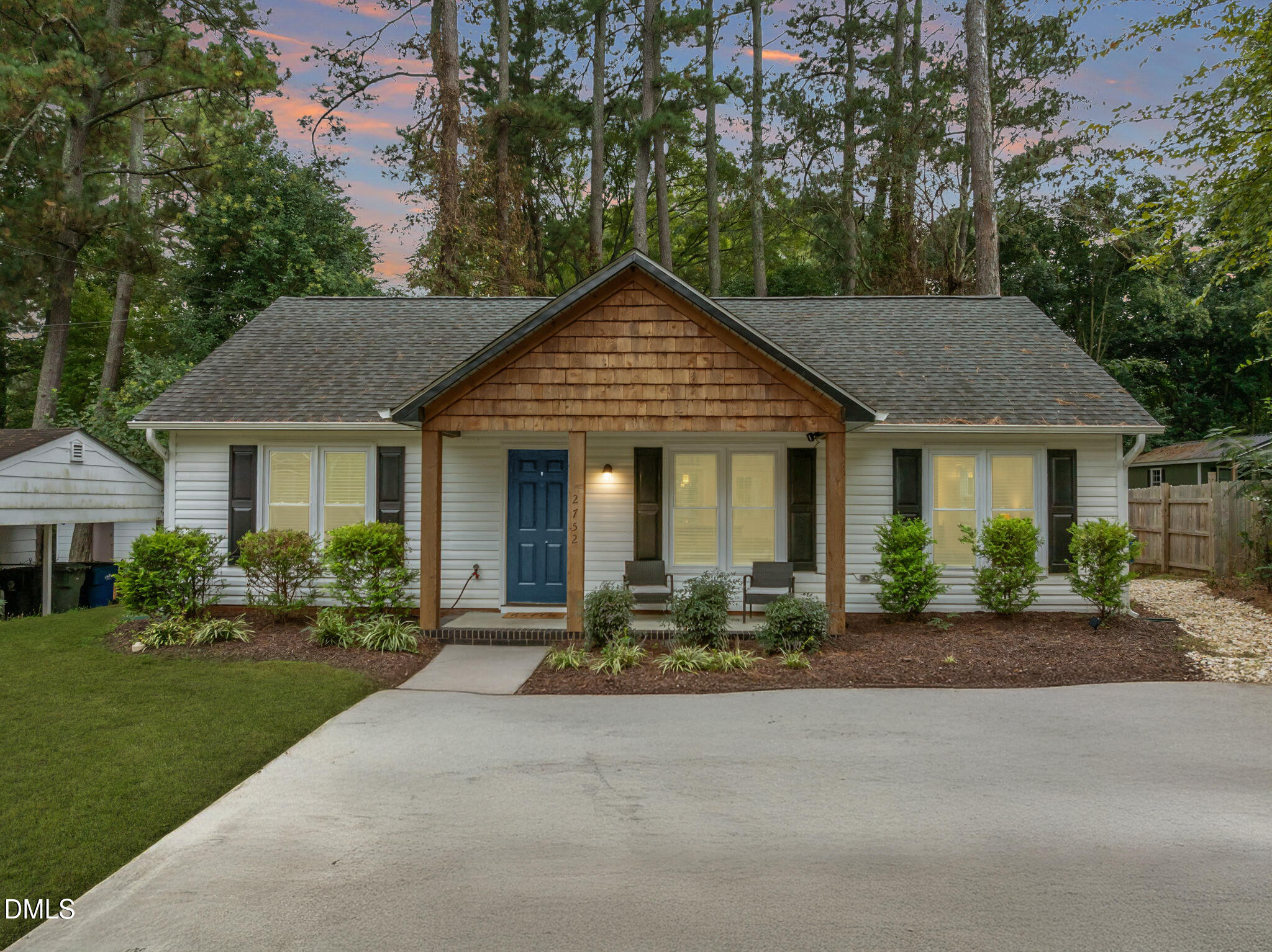 a front view of a house with a yard and outdoor seating