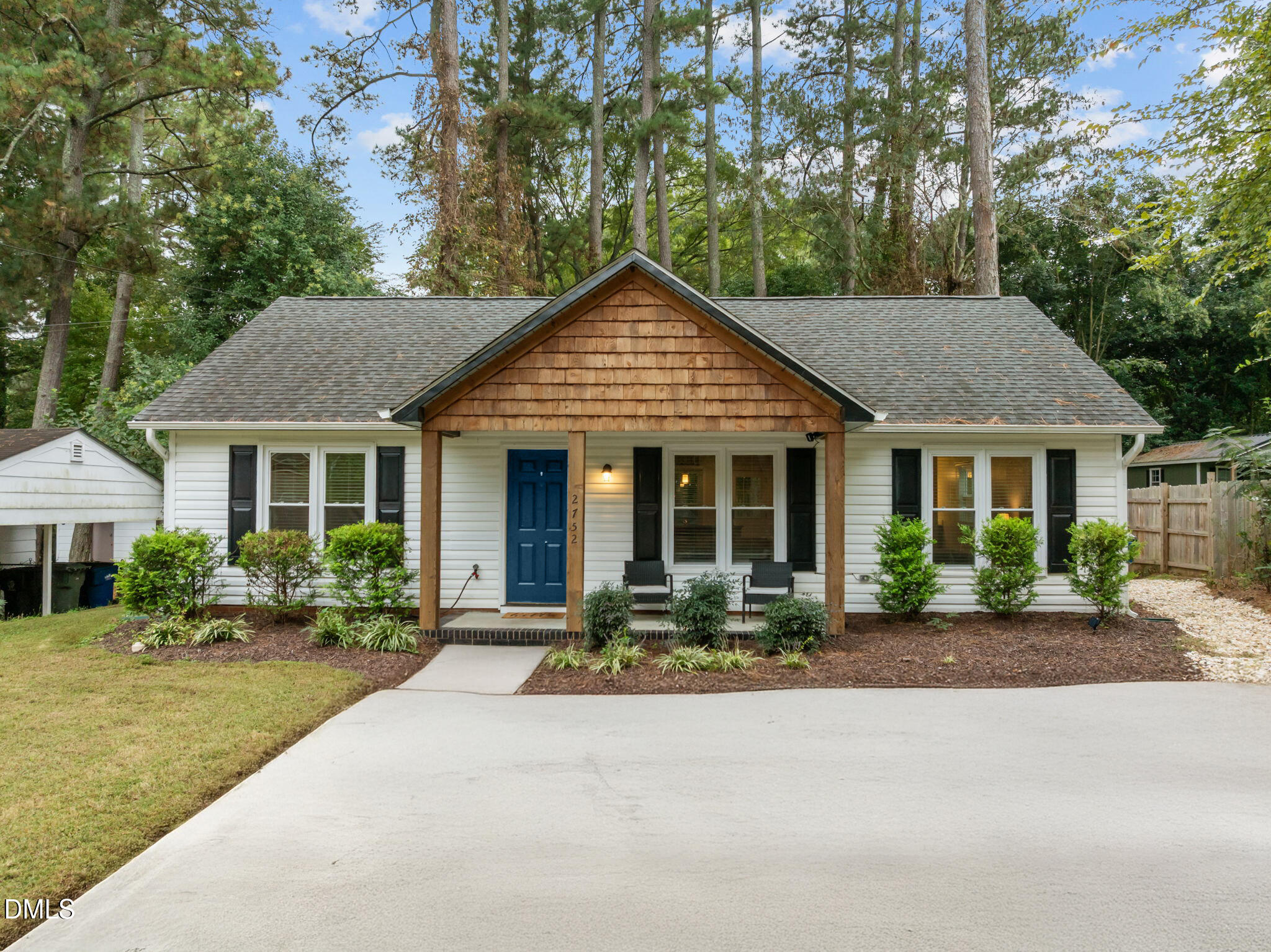 a front view of a house with garden and porch