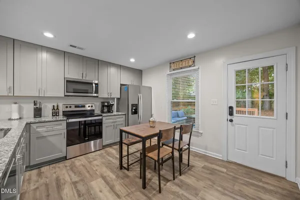 a view of a dining room with furniture window and wooden floor