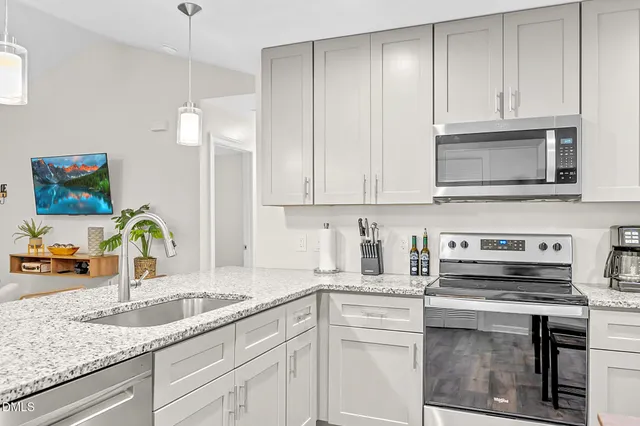a kitchen with a table chairs refrigerator and microwave