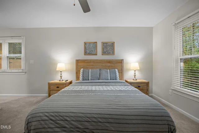 a bathroom with a granite countertop sink a toilet and a mirror