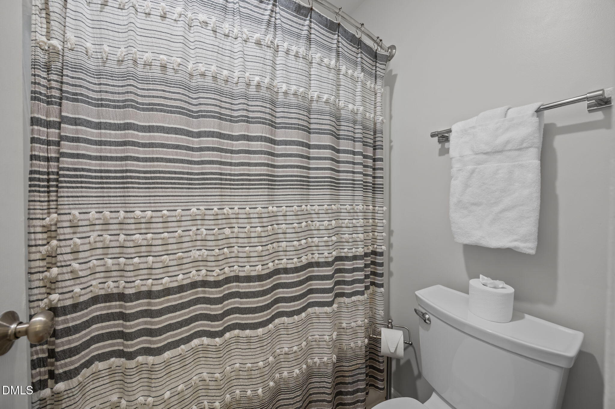 2752 Milburnie Road Raleigh, NC 27610 - Photo 23 of 54 a bathroom with a toilet and a shower curtain