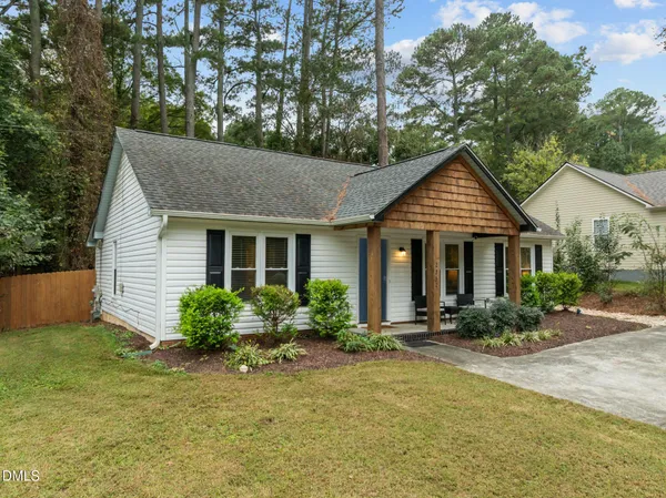 a front view of a house with a yard and outdoor seating