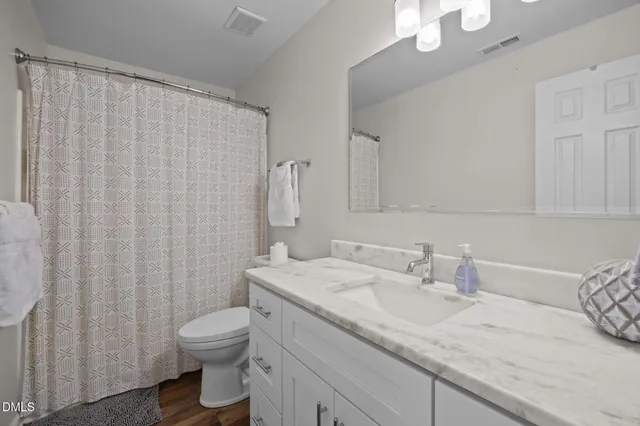 a view of brick house with potted plants