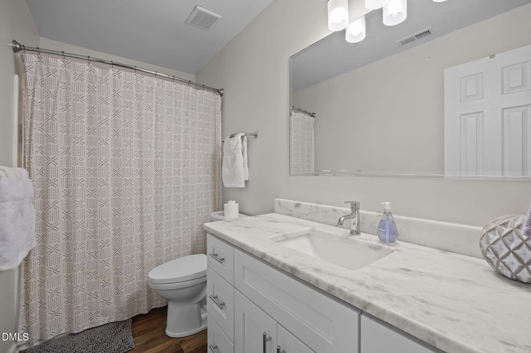 2752 Milburnie Road Raleigh, NC 27610 - Photo 28 of 54 a bathroom with a granite countertop sink and a toilet