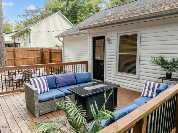 a view of a patio with couple of chairs and a potted plant