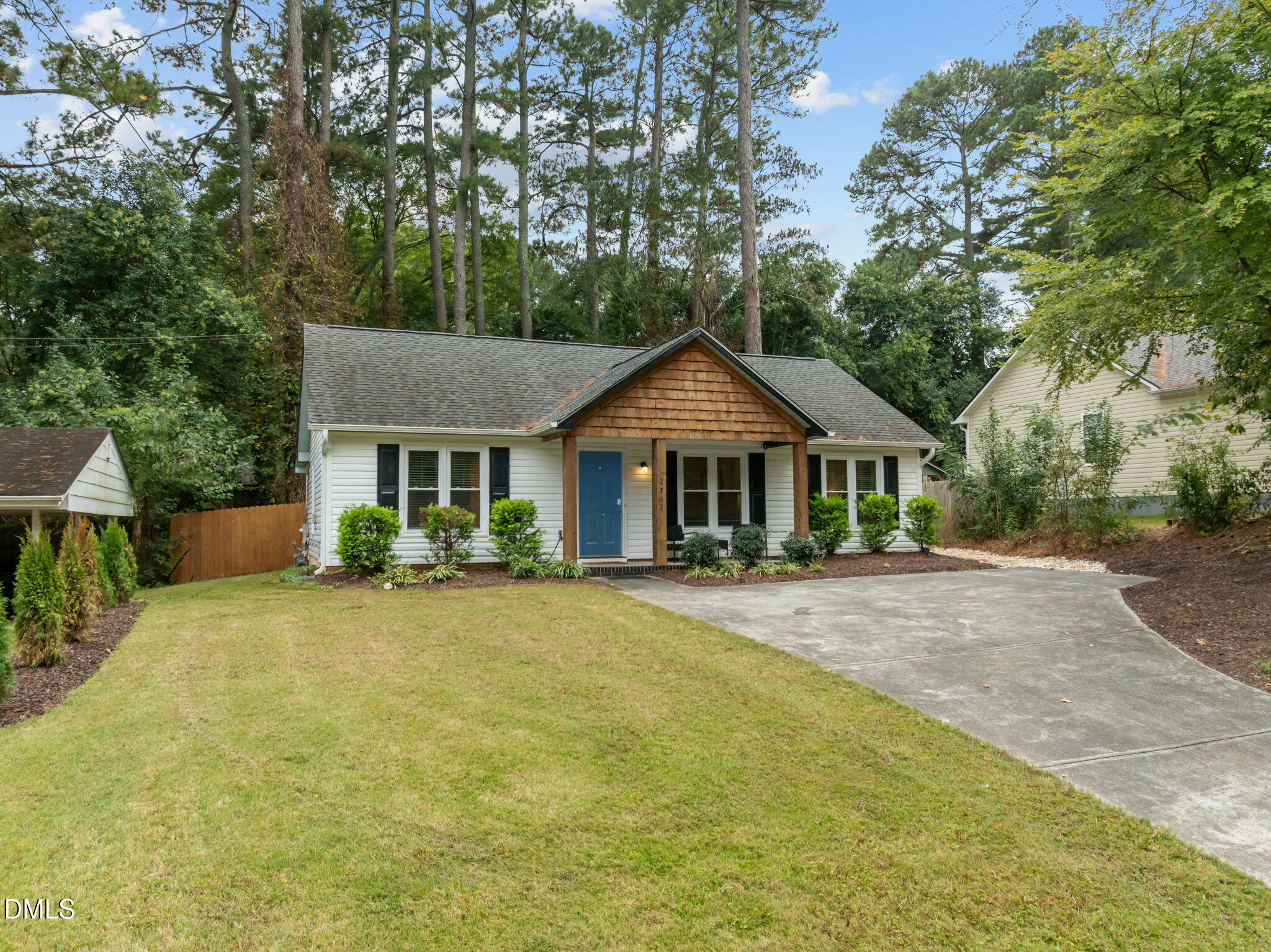 2752 Milburnie Road Raleigh, NC 27610 - Photo 31 of 54 a front view of a house with yard and trees