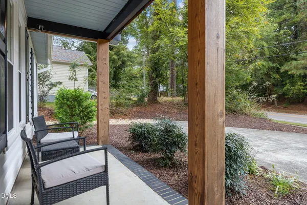 a roof deck with couches and wooden fence