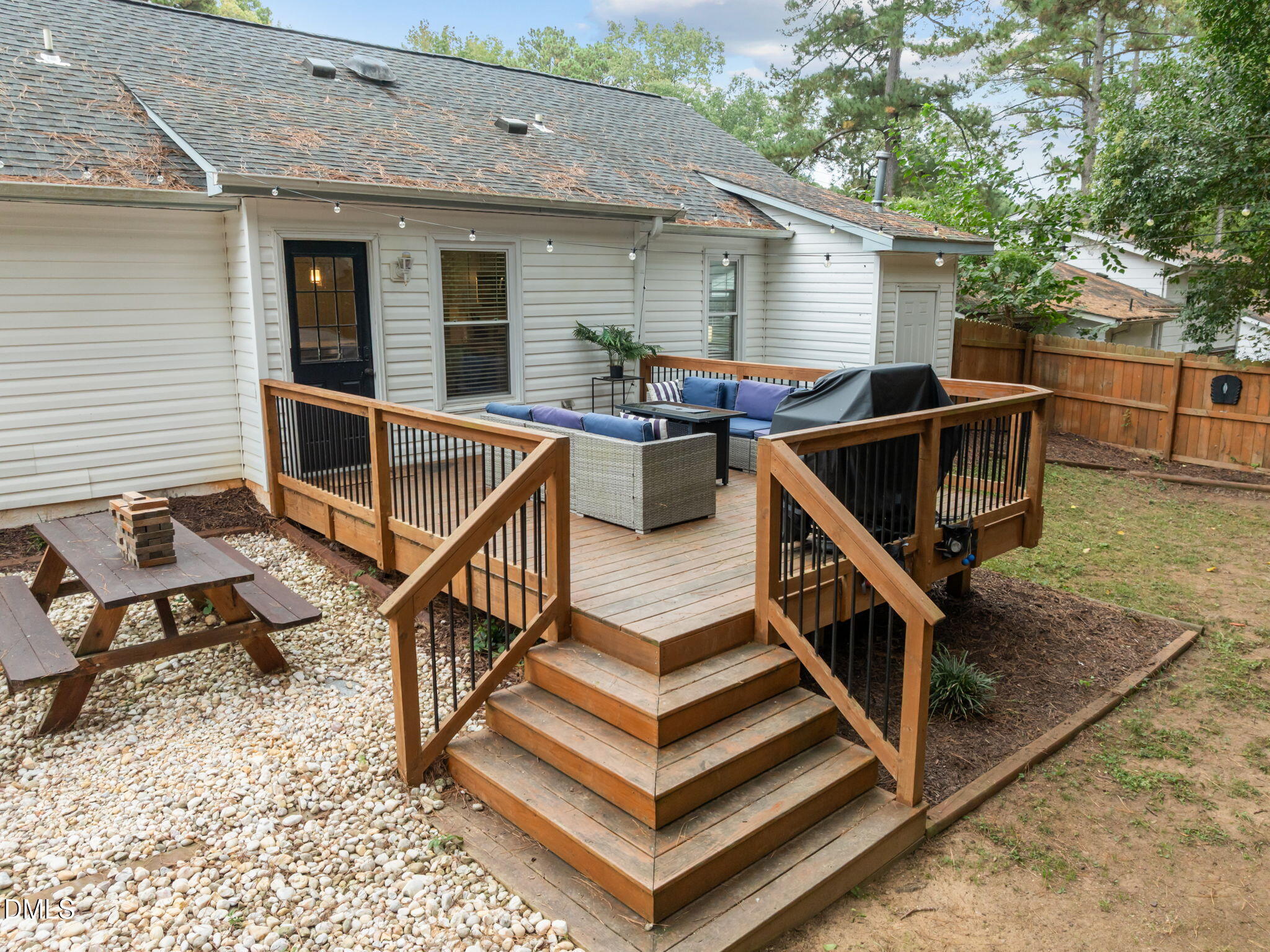 2752 Milburnie Road Raleigh, NC 27610 - Photo 36 of 54 a view of house with wooden deck and a barbeque