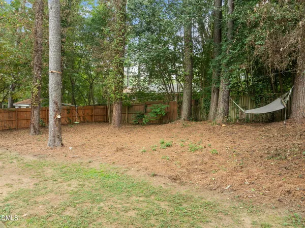 an aerial view of a house with swimming pool and next to a yard