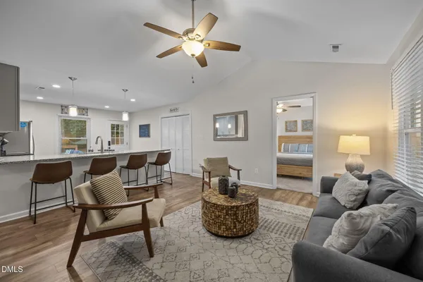a living room with furniture and a wooden floor
