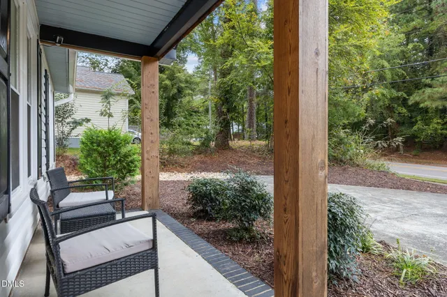 a view of backyard with plants and outdoor seating