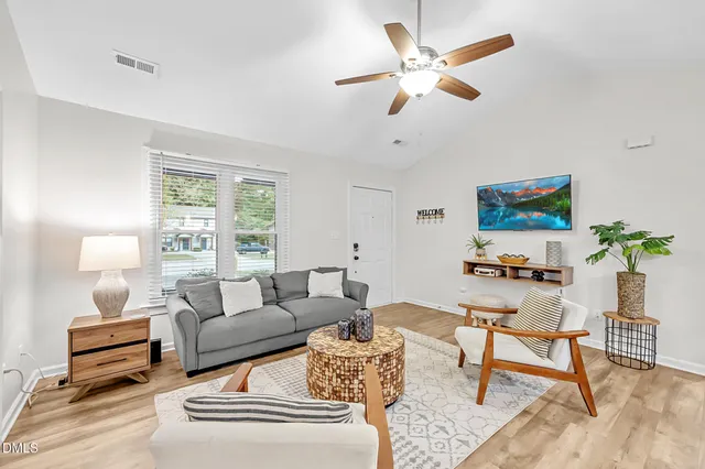 a living room with furniture a rug and a window