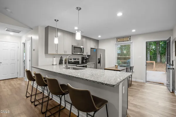 a kitchen with a sink stove and microwave