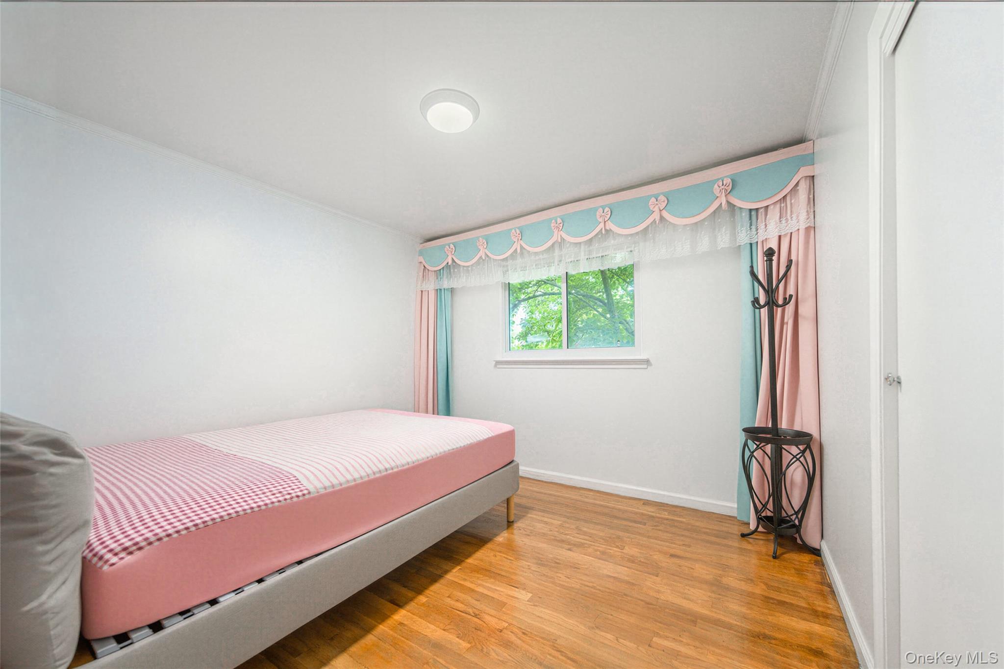 105 Seaman Road Jericho, NY 11753 - Photo 4 of 11 a bedroom with a bed and a window