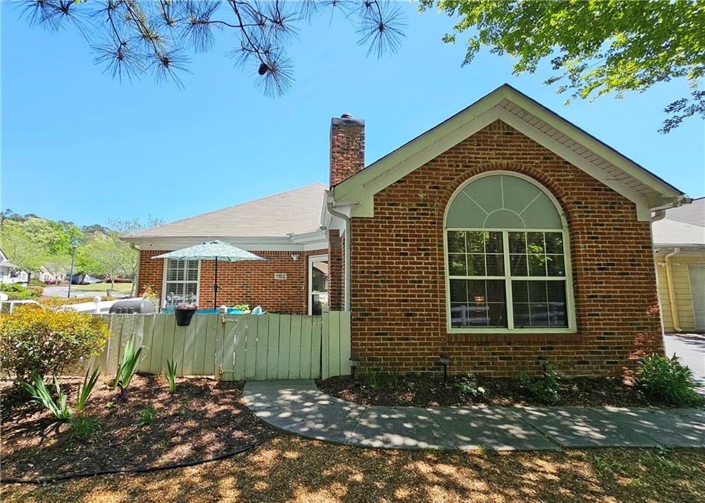 2191 Rockbridge Road Southwest, Unit 1102 Stone Mountain, GA 30087 - Photo 1 of 1 a front view of a house with a yard