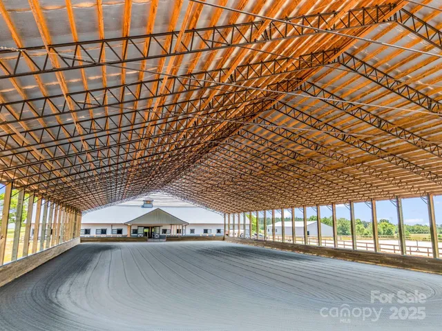 a room with a wooden floor and windows