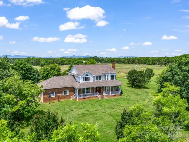 a aerial view of a house with a garden and a yard