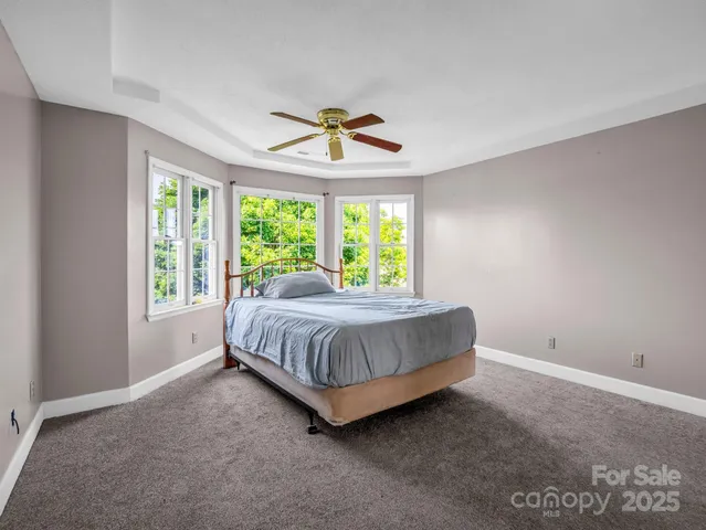 a spacious bedroom with a bed and a window