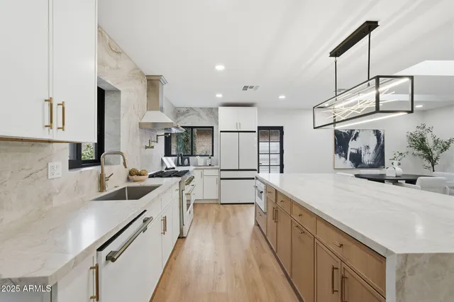 a living room with furniture and floor to ceiling windows