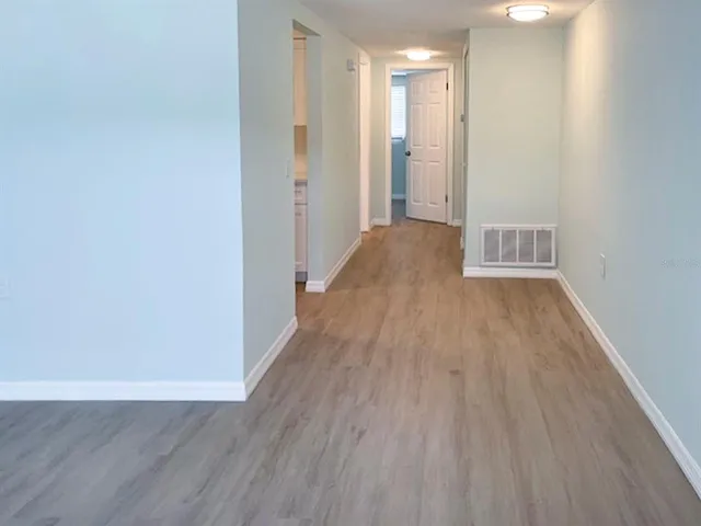 a view of hallway with wooden floor