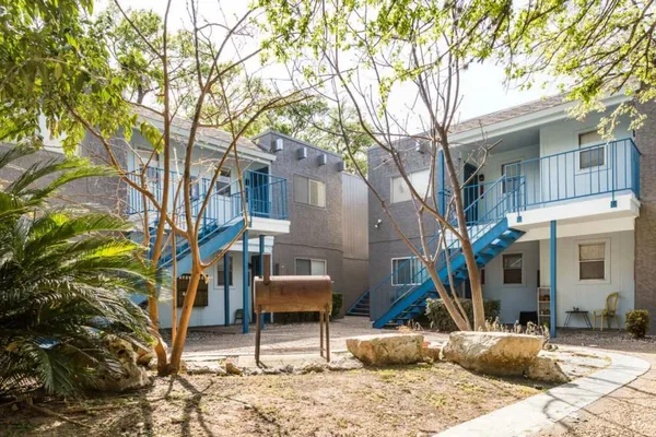 a backyard of a house with table and chairs