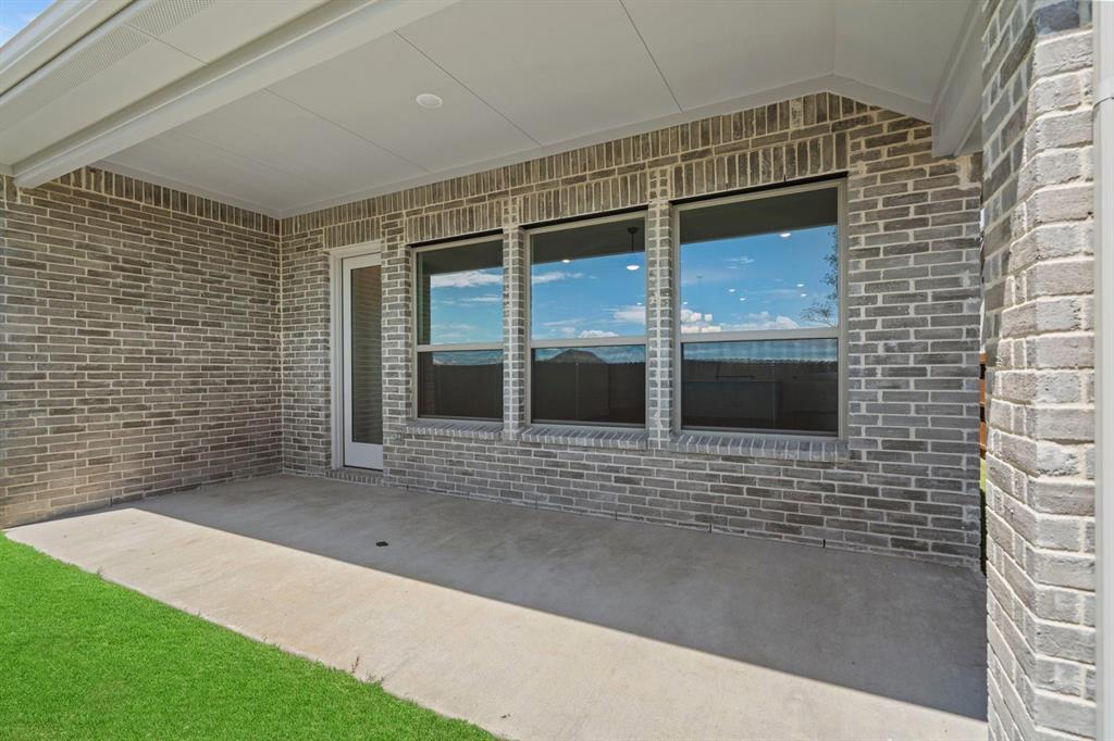 1792 Monarch Way Oak Point, TX 75068 - Photo 23 of 26 a view of a brick house with a large door