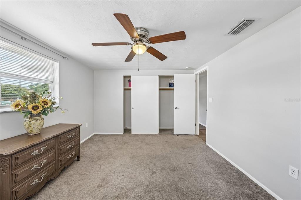 7215 Mayfield Drive Port Richey, FL 34668 - Photo 7 of 52 a view of an empty room and cabinet with wooden floor