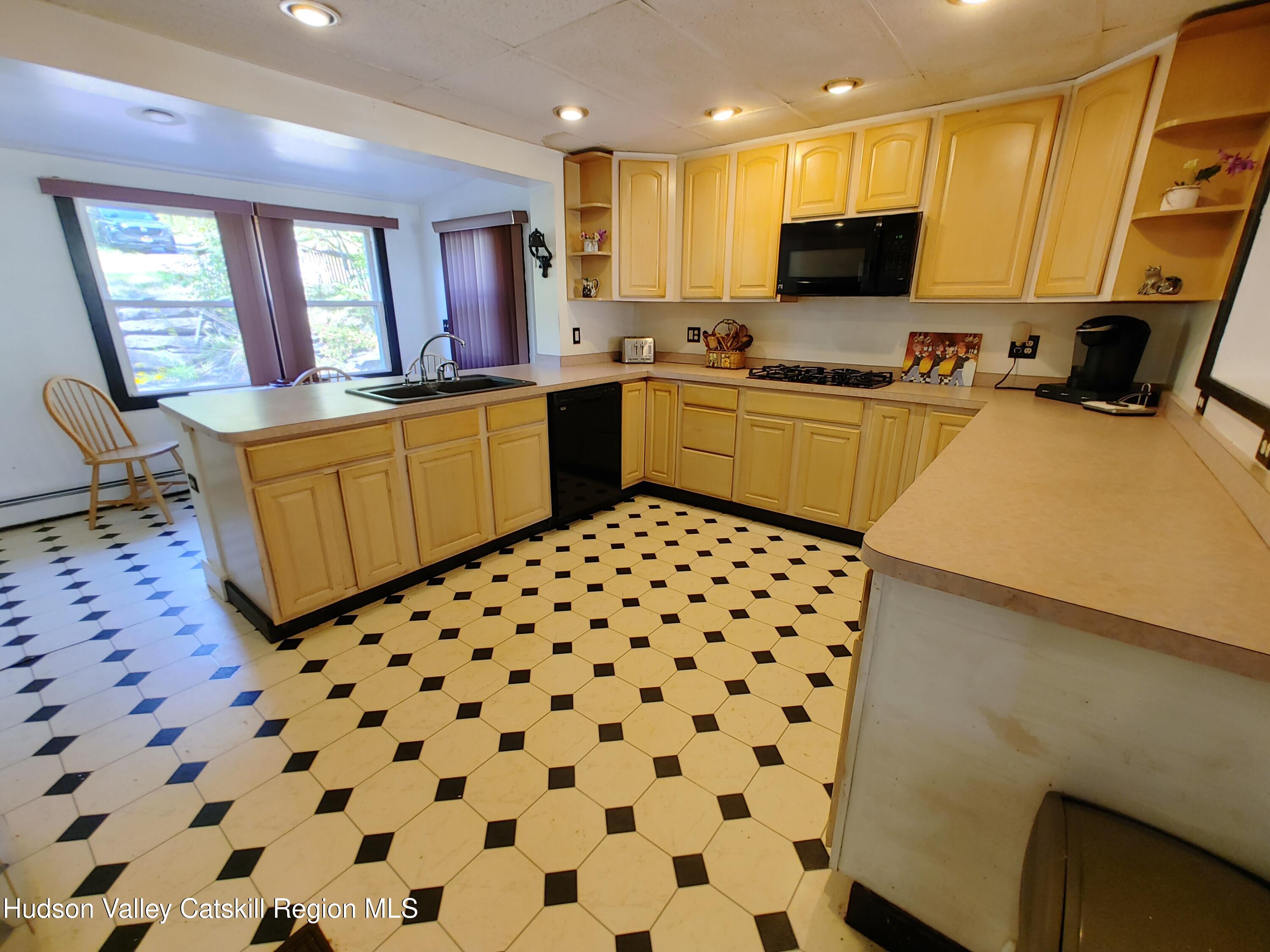 11 Old Turnpike Road Pine Hill, NY 12465 - Photo 20 of 64 a kitchen with a sink a stove a microwave a counter top space and cabinets