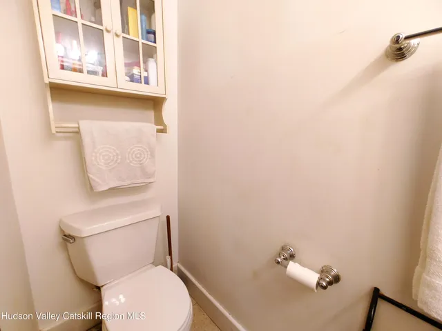 a bed sitting in a spacious bedroom next to a window