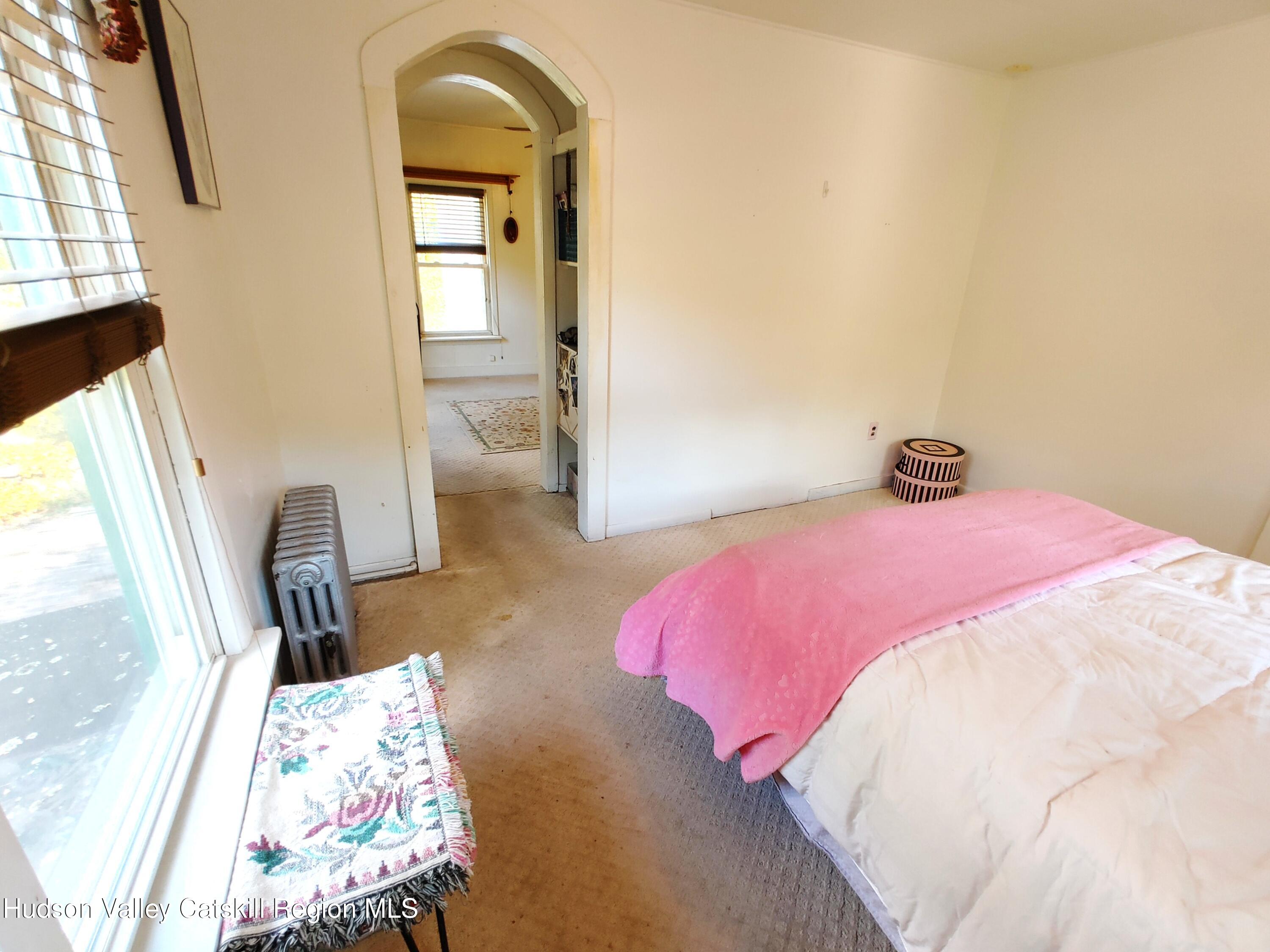 11 Old Turnpike Road Pine Hill, NY 12465 - Photo 48 of 64 a bedroom with a bed and a large mirror next to a window