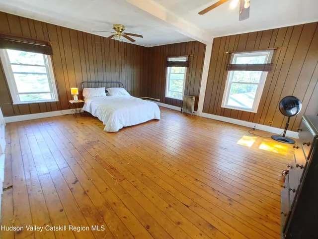an empty room with windows and closet