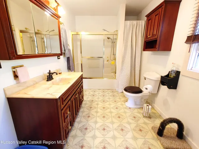 a bedroom with a bed and a lamp on table