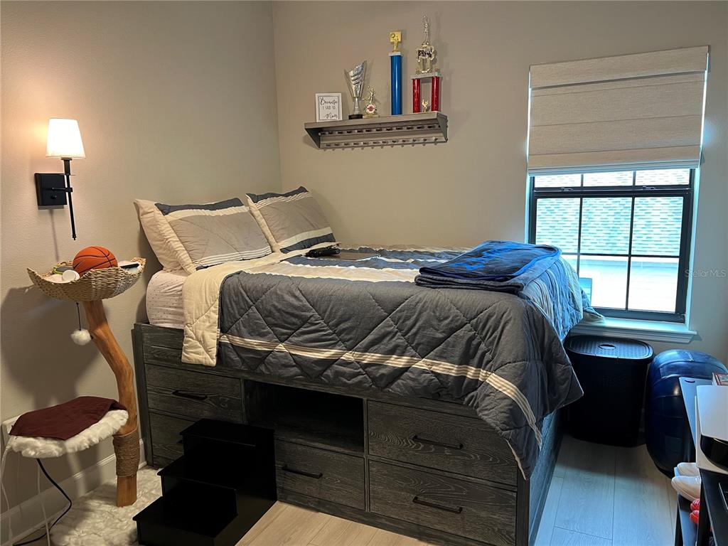 1266 Spotted Sandpiper Loop Winter Springs, FL 32708 - Photo 18 of 21 a bedroom with a bed and a window