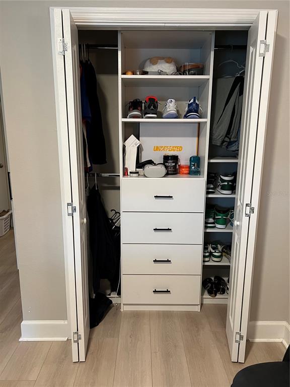1266 Spotted Sandpiper Loop Winter Springs, FL 32708 - Photo 19 of 21 a view of walk in closet with clothes and shoes