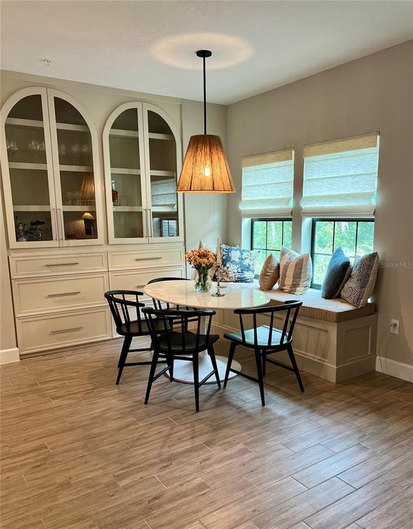 1266 Spotted Sandpiper Loop Winter Springs, FL 32708 - Photo 3 of 21 a view of a dining room with furniture window and wooden floor