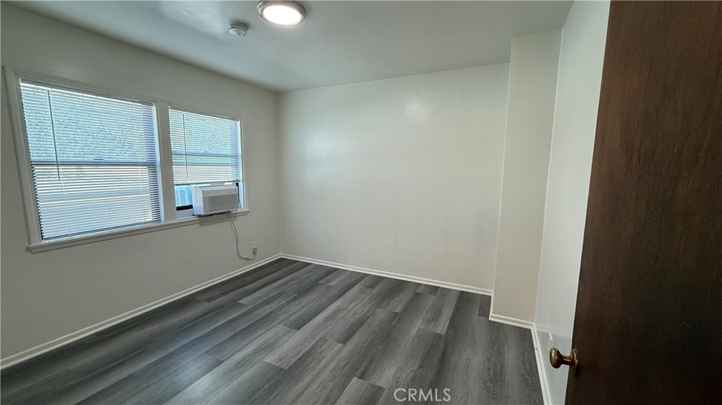 337 South Occidental Boulevard, Unit 5 Los Angeles, CA 90057 - Photo 11 of 16 an empty room with wooden floor and windows