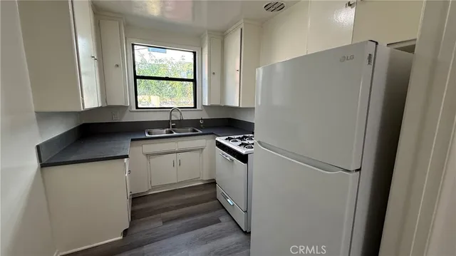 a kitchen with a refrigerator and a sink