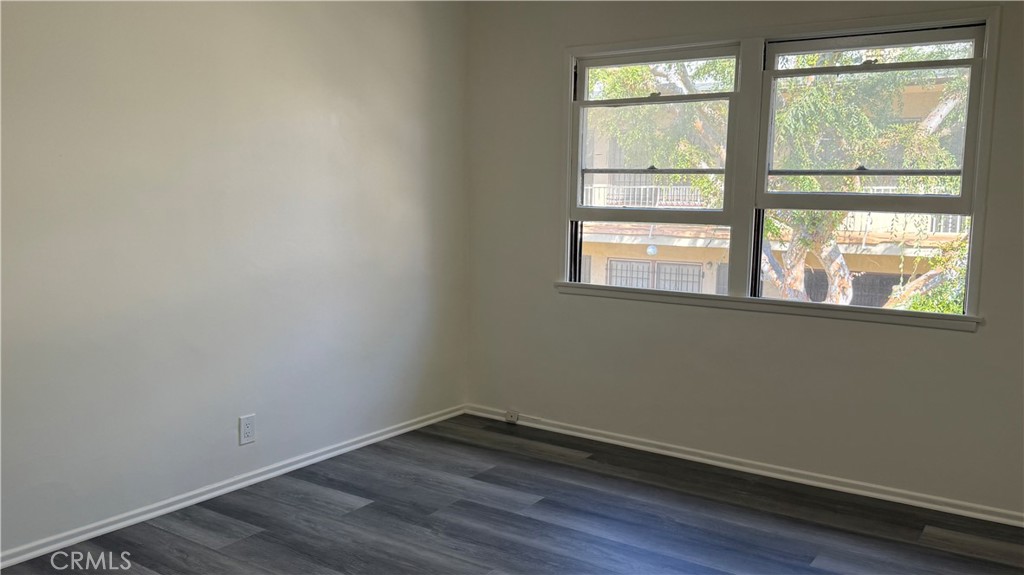 337 South Occidental Boulevard, Unit 5 Los Angeles, CA 90057 - Photo 4 of 16 a view of an empty room with wooden floor and a window