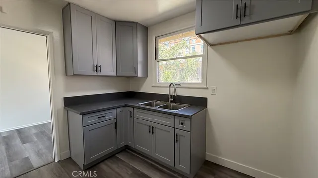 a kitchen with a sink cabinets window and cabinets