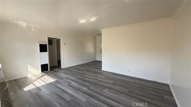 a view of a room with wooden floor and brick walls