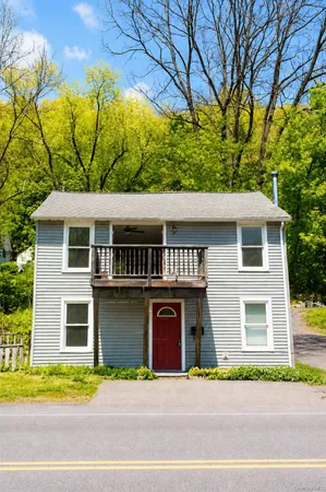 a front view of a house with a garden and garage