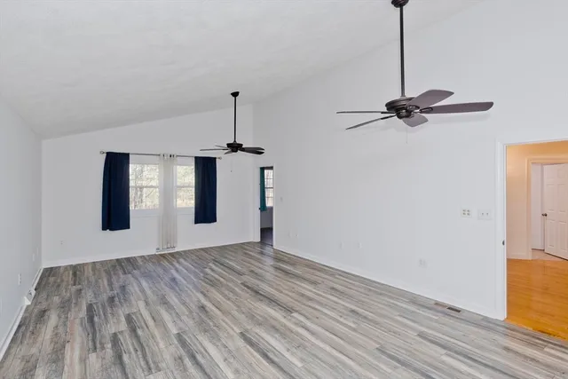 a view of empty room with ceiling fan