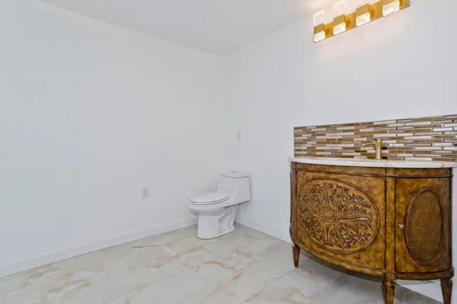 a view of a livingroom with wooden floor and a window