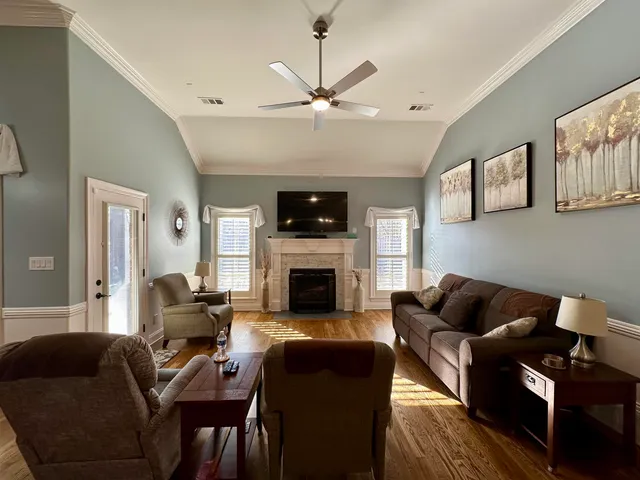 a kitchen with a table chairs and white cabinets